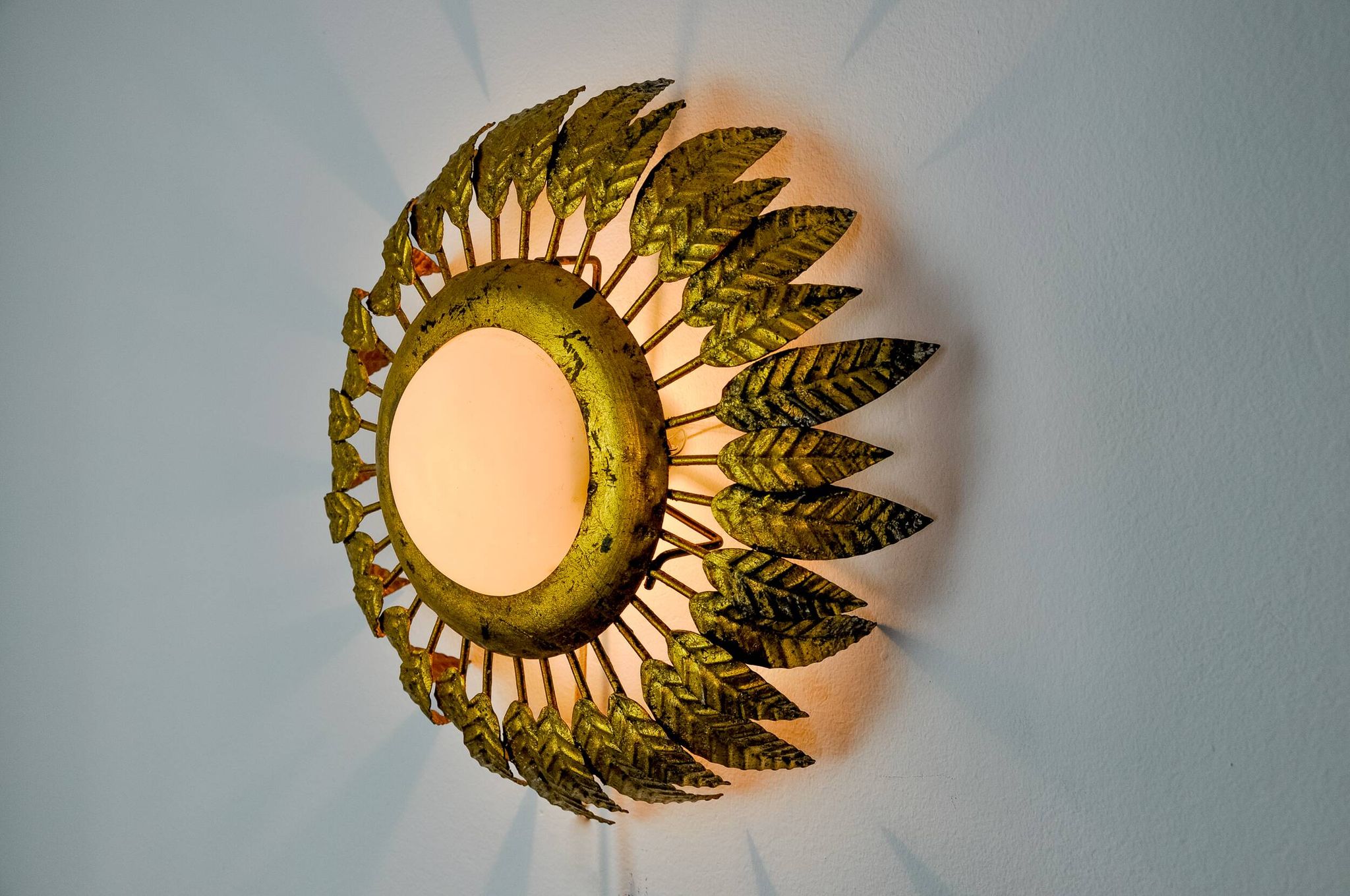 Sun wall lamp by ferro arte, metal and gold leaf and opaline glass, Spain, 1960