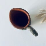 Old pitcher in glazed terracotta