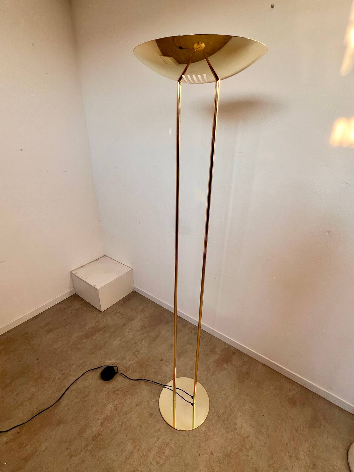 Old golden brass floor lamp with Italian design bulb from the 70s vintage