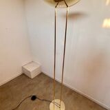 Old golden brass floor lamp with Italian design bulb from the 70s vintage