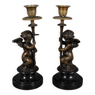 Pair of Napoleon III candlesticks decorated with 19th century putti in bronze