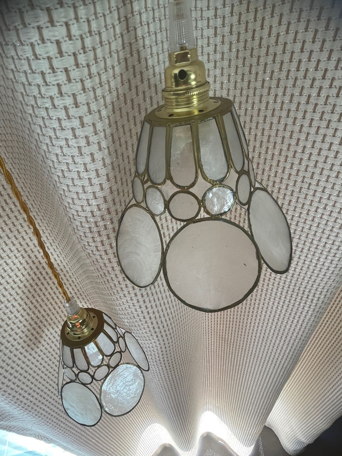 Pair of portable lamps with mother-of-pearl lampshades and brass.