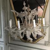 Venetian mirror topped with half a chandelier of Murano