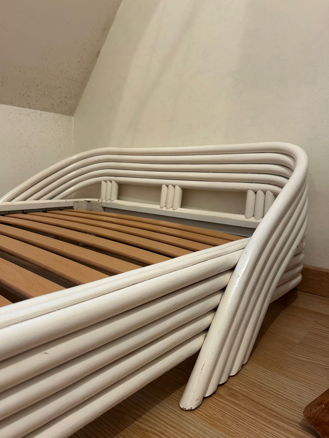 Vintage white rattan bed from the 1960s.