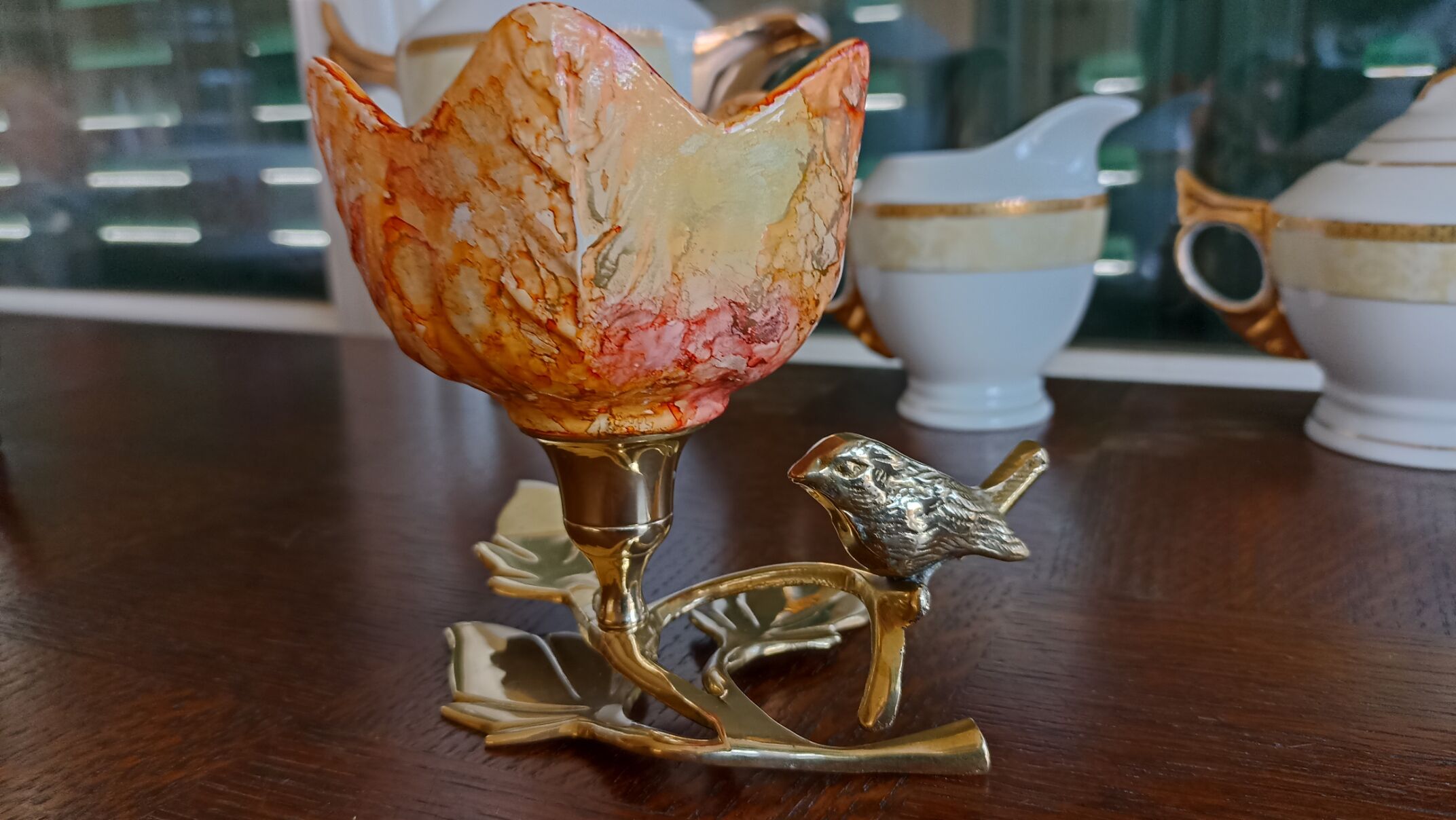 Brass cup in the shape of a bird and flowers