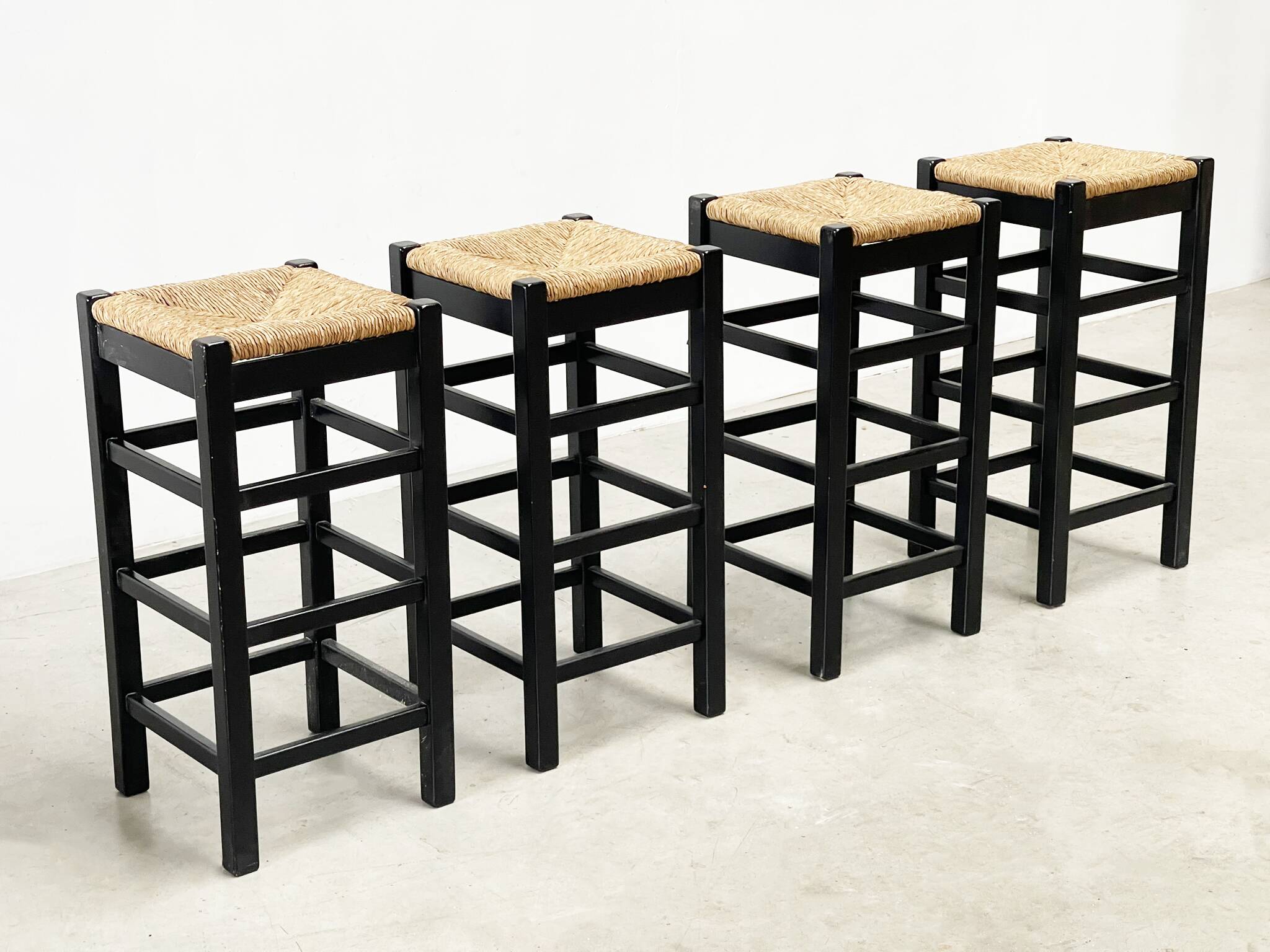 set of four rattan and wood barstools