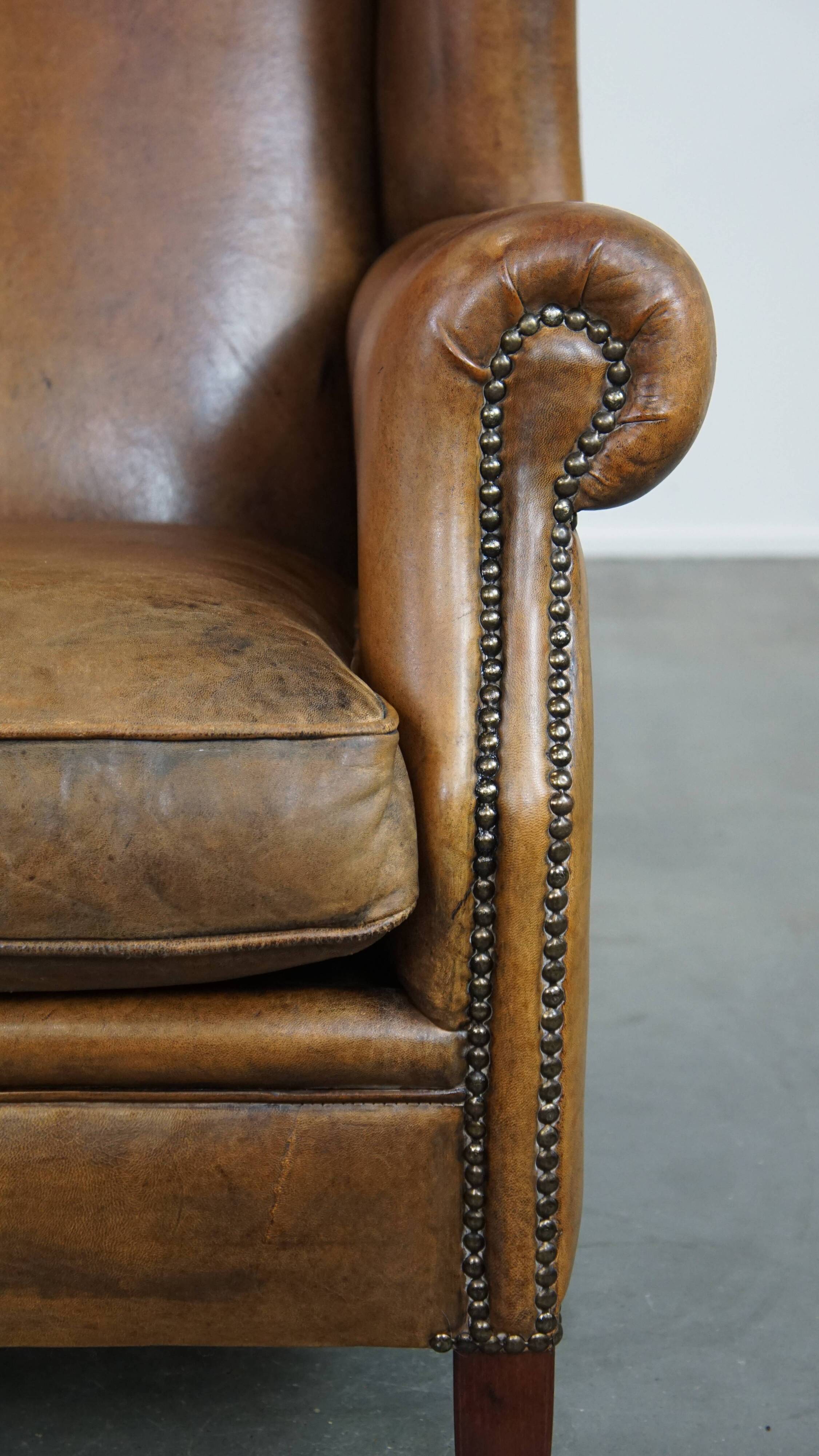 Sheep leather wingback chair with patina