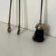 Neoclassical brass fire accessory.