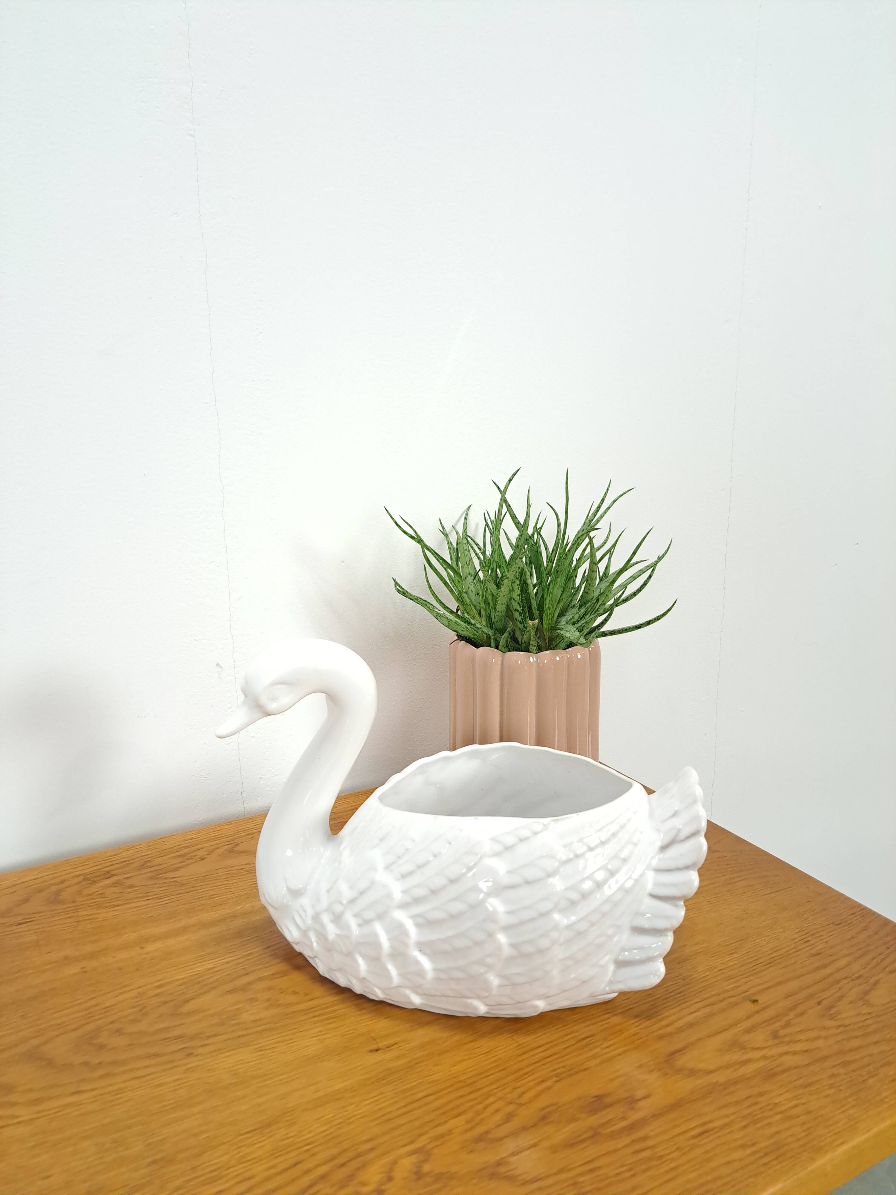 vintage porcelain flower pot in the shape of a swan