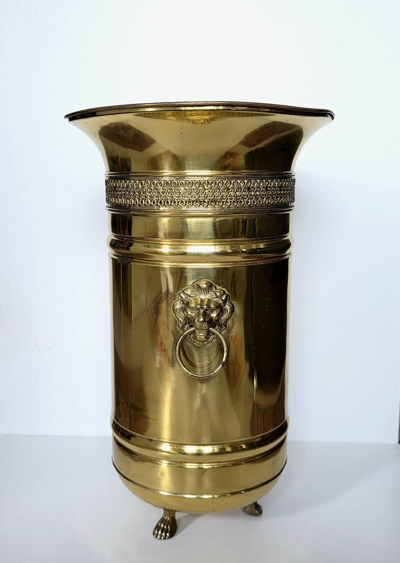 Hollywood Regency style umbrella stand, brass finish and lio pattern.