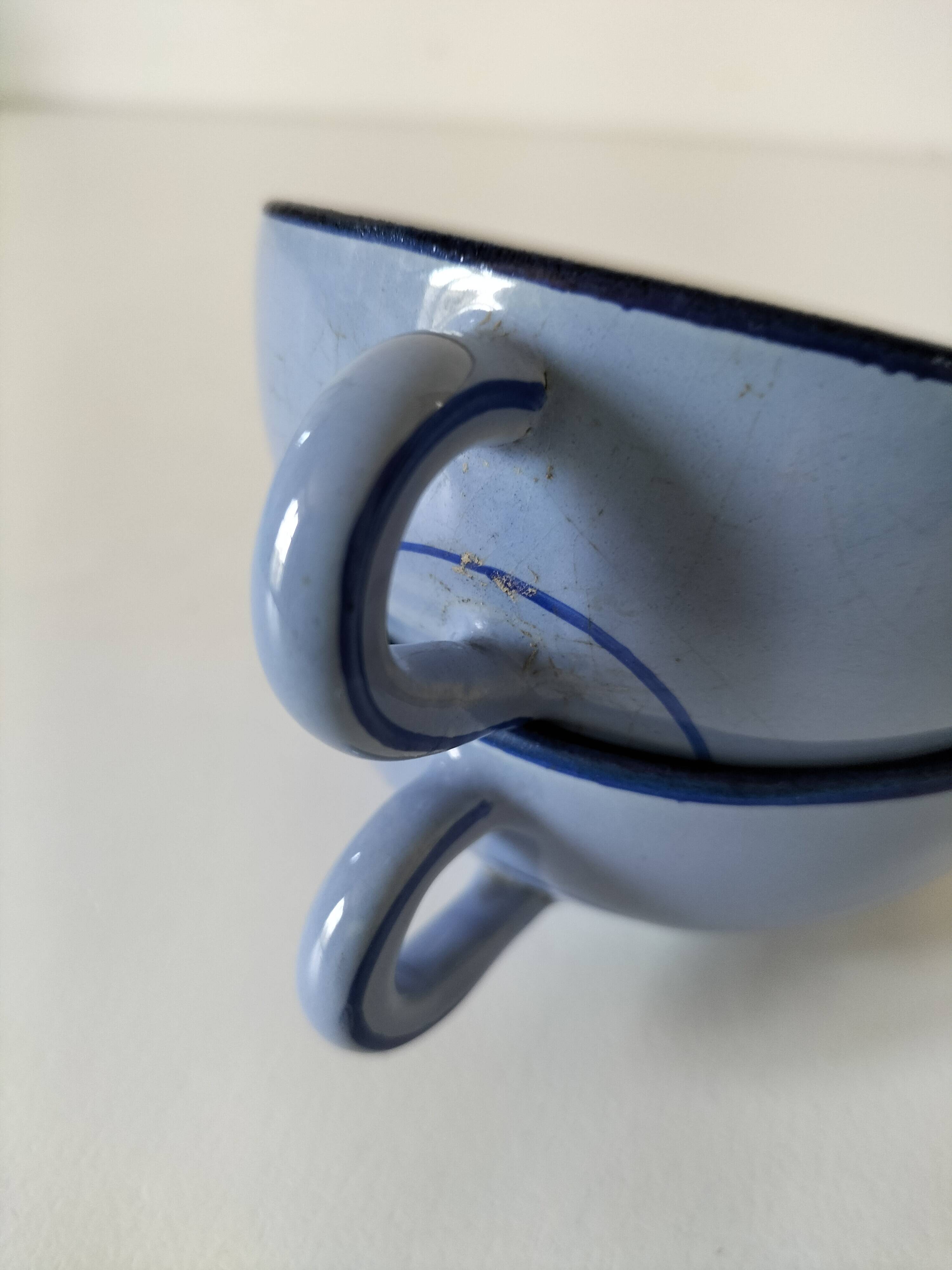 A pair of glazed ceramic cups and saucers from the 60s-70s.