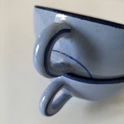 A pair of glazed ceramic cups and saucers from the 60s-70s.