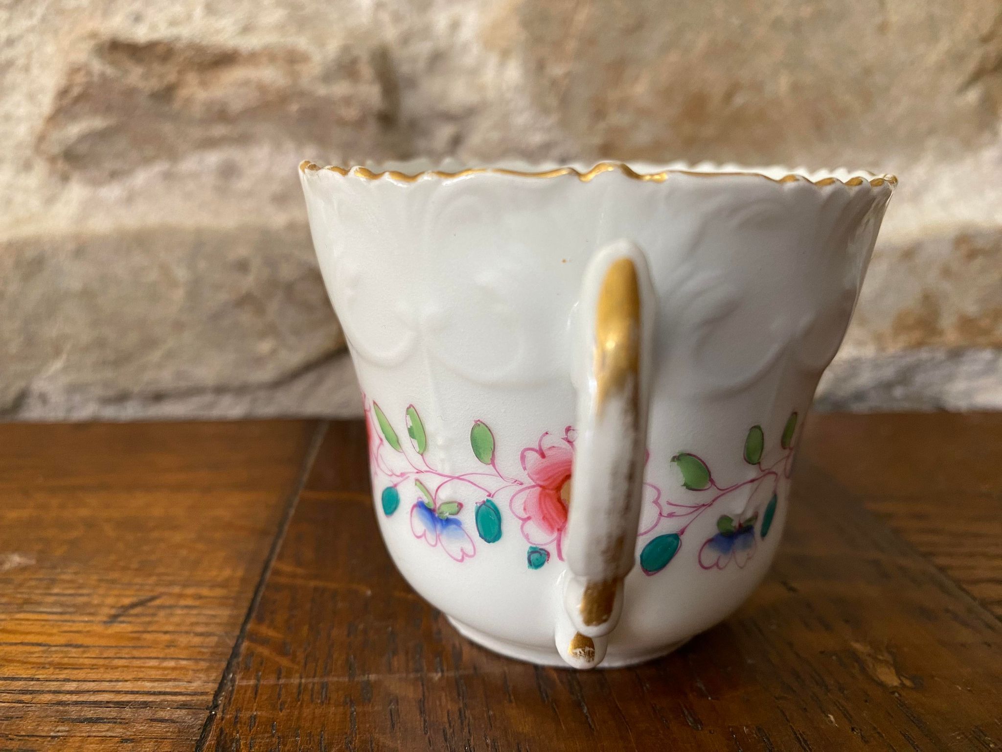 Porcelain cup with chiseled and gilded rim