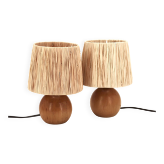 Pair of round wooden lamps with raffia shades, 1970s.