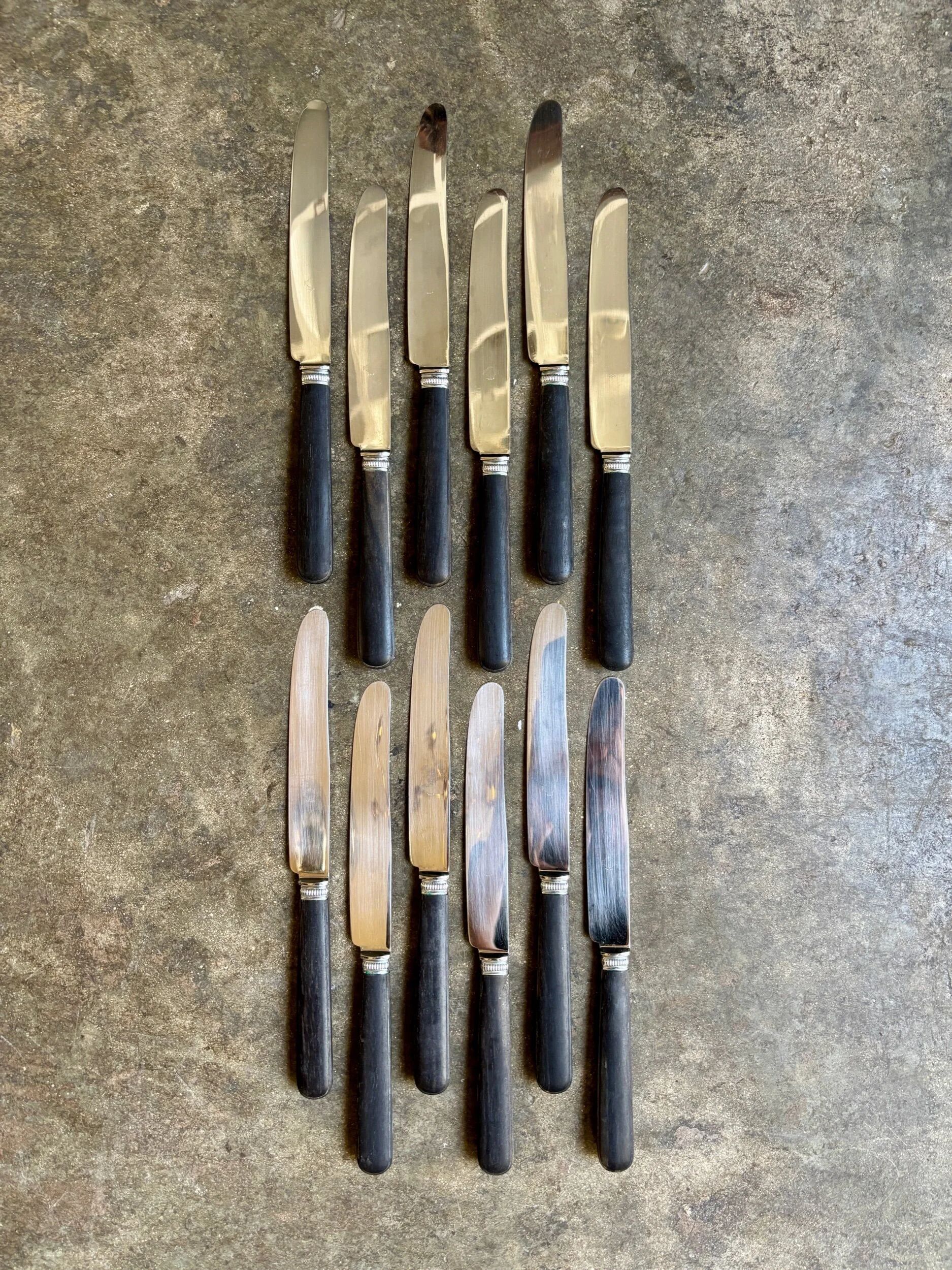 12 blackened wooden knives