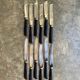 12 blackened wooden knives
