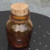 Blown and bubbled glass jar in the style of Biot glassworks, amber color