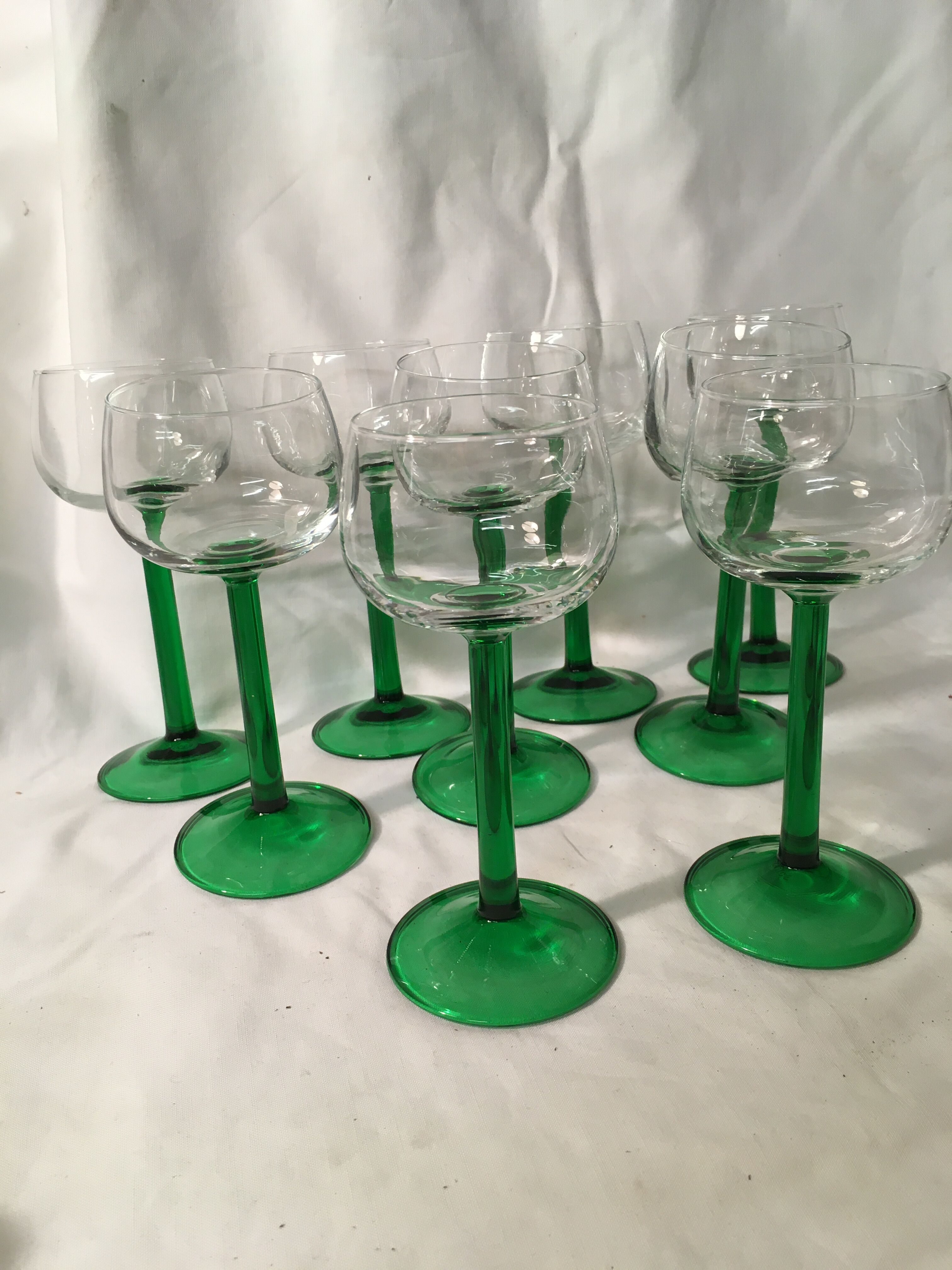 9 glasses of white wine (green feet)