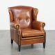 Sheepskin wingback armchair with stitching and black piping