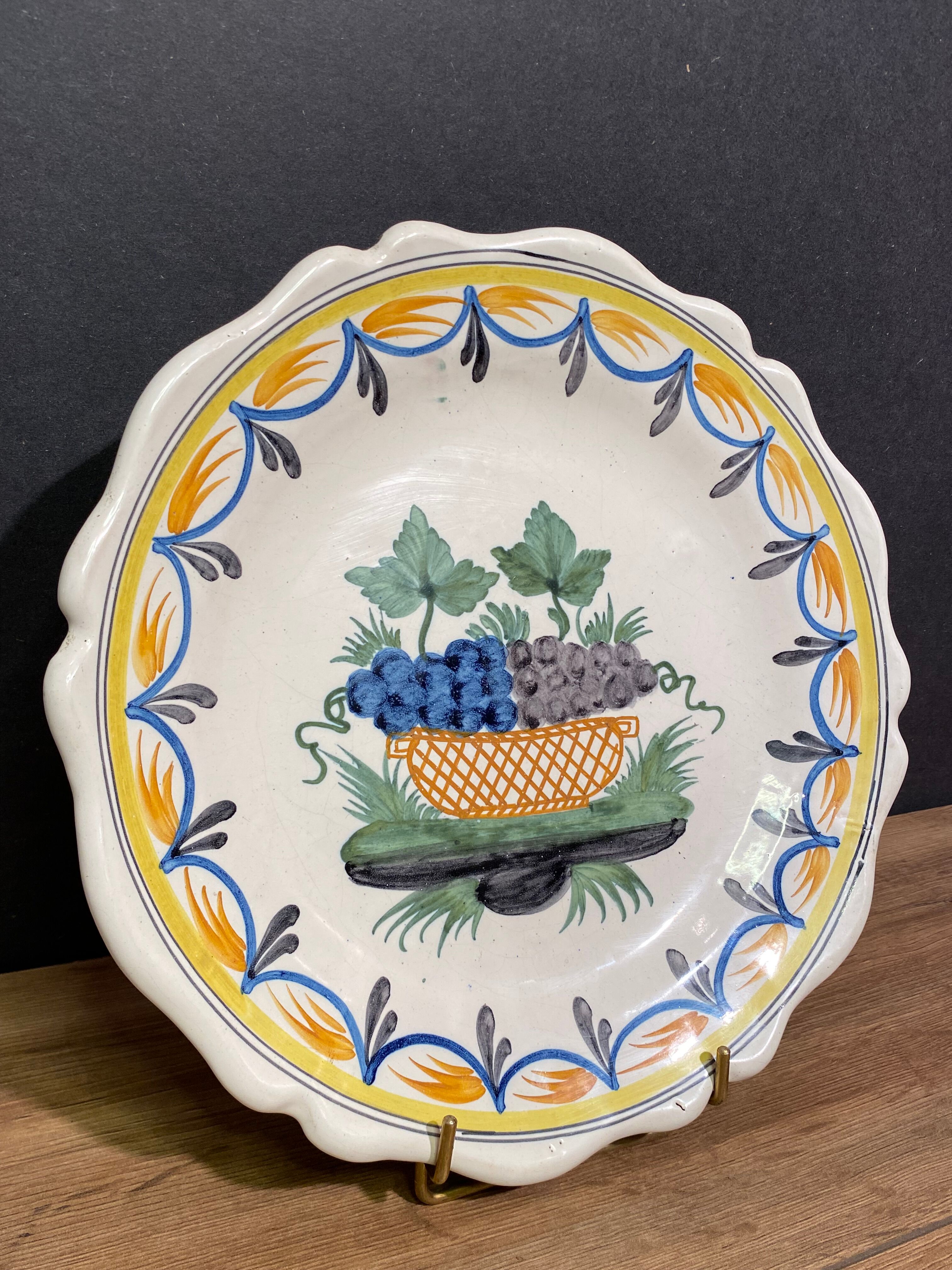 Faience dish of eighteenth-century style nevers decorated with basket with bunches of grapes