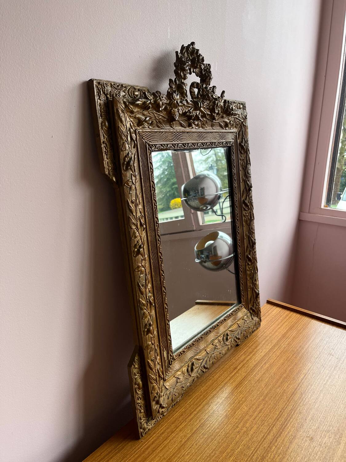Golden trumeau mirror for fireplace, late 19th century, with sculpted pediment.