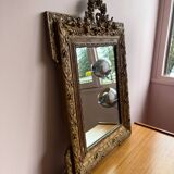 Golden trumeau mirror for fireplace, late 19th century, with sculpted pediment.