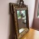 Golden trumeau mirror for fireplace, late 19th century, with sculpted pediment.