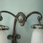 Wall lamp in wrought iron with a pink tulip glass globe by Muller glassworks.