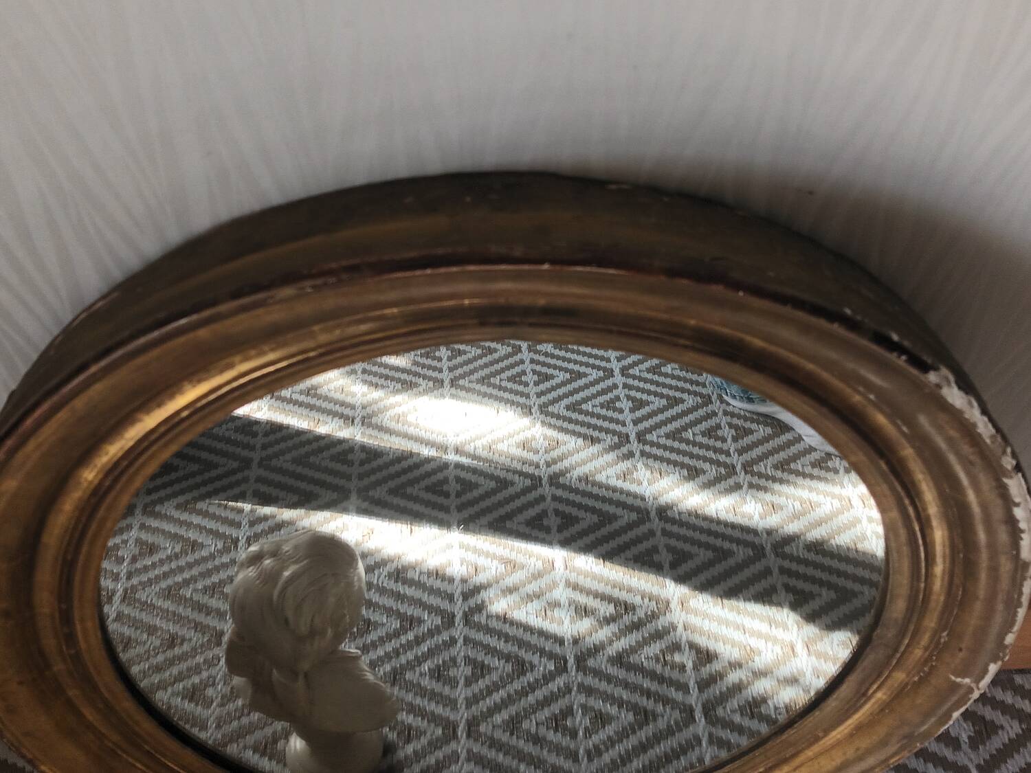 Antique oval gilded stucco mirror