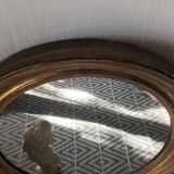 Antique oval gilded stucco mirror