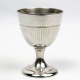 Four silver-plated Christofle egg cups with fluted sides.