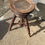 Adjustable brown leather piano stool with turned legs, produced in the 1940s.
