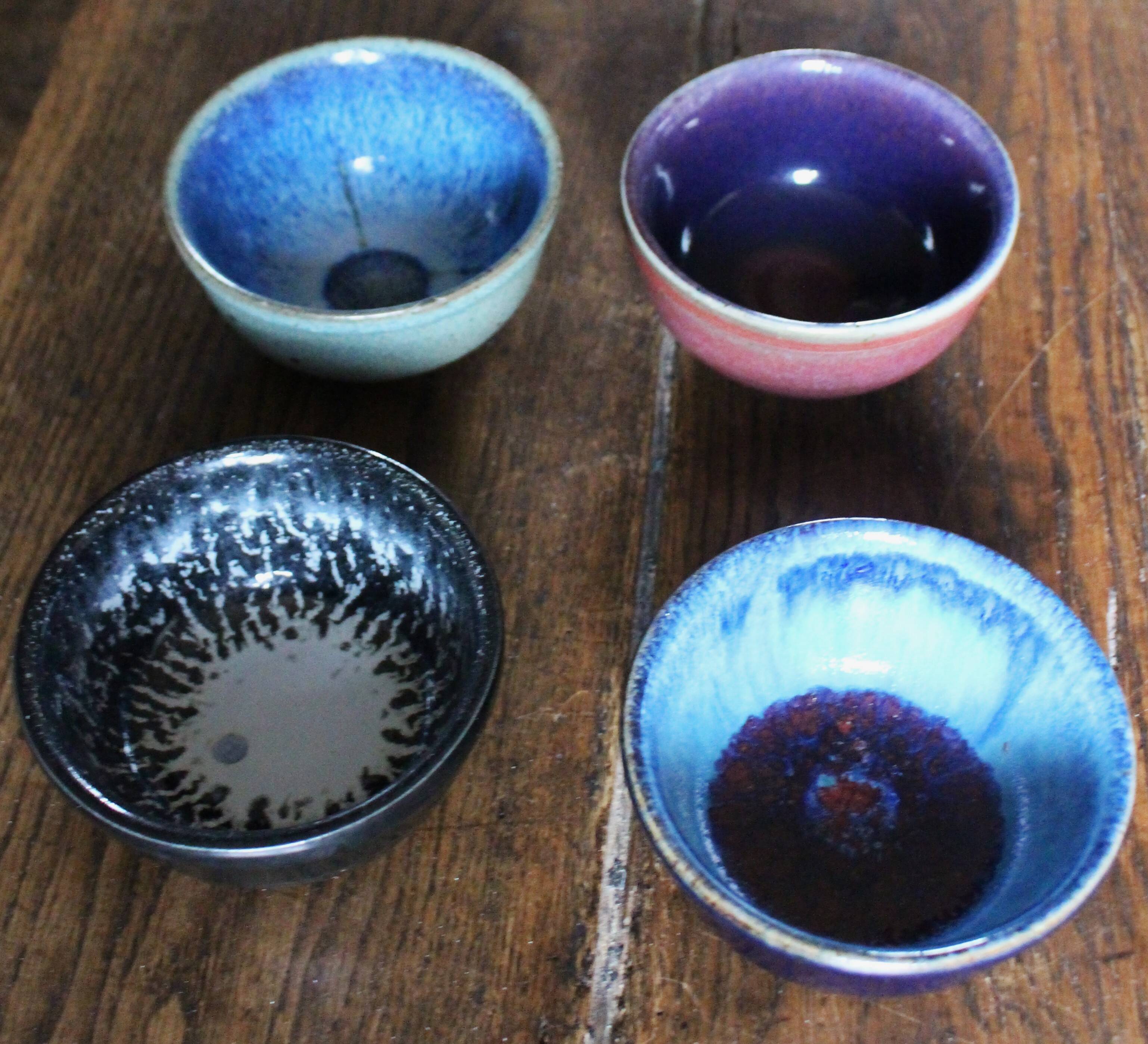 A set of 4 pottery bowls in coloured glaze.