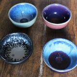 A set of 4 pottery bowls in coloured glaze.