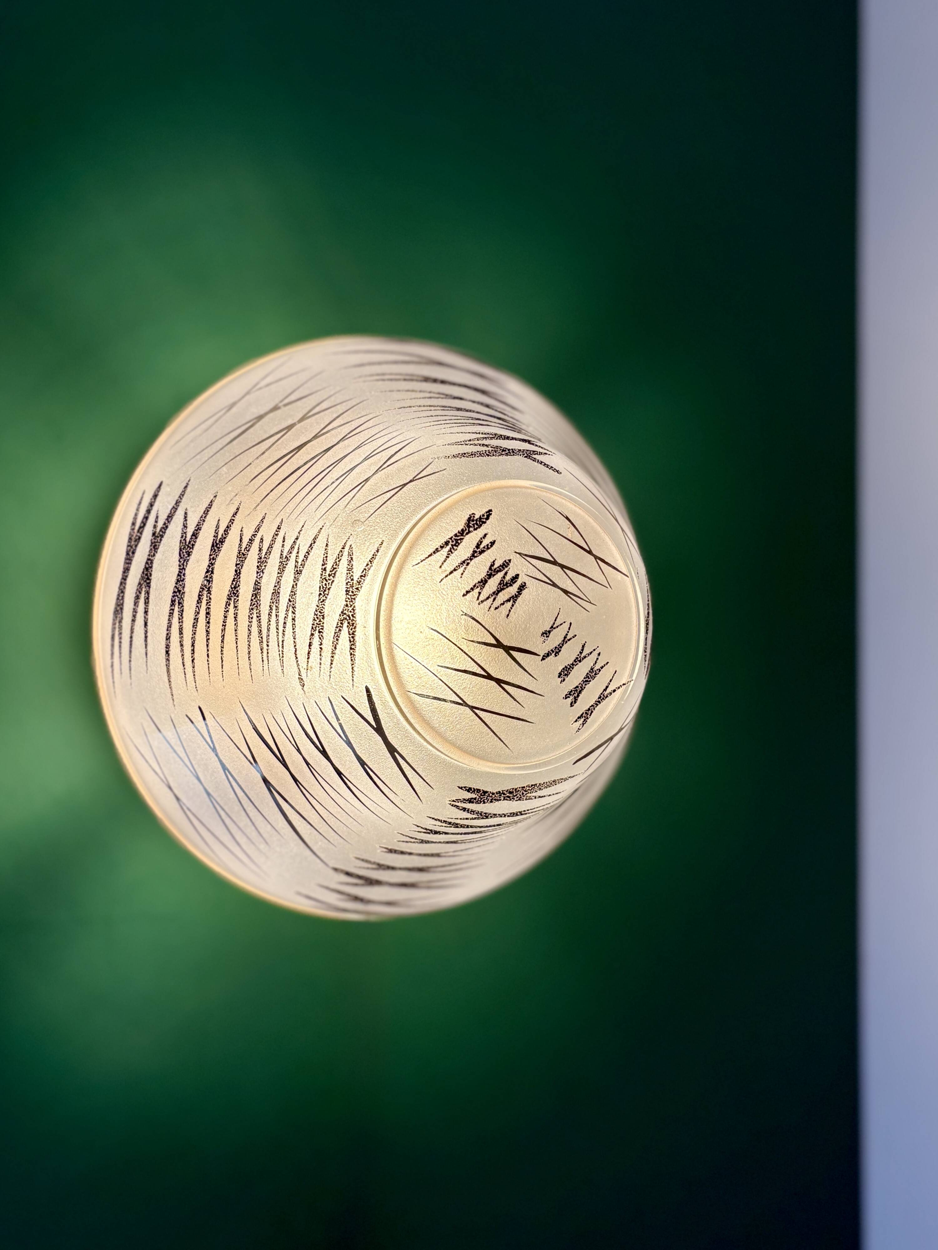 Vintage Art Deco globe wall/ceiling light in white, black, and gold glass.