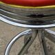 Set of 5 vintage swivel bar stools in blue, red, orange, and yellow.