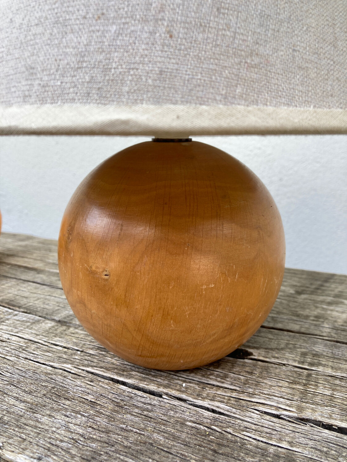 Wooden ball bedside lamp and beige lampshade