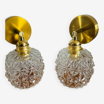 Pair of articulated wall lights on antique chiseled glass globes