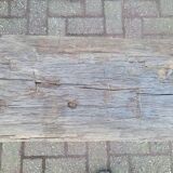 French country style cast iron bench with old rustic wooden plank