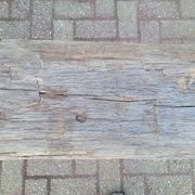 French country style cast iron bench with old rustic wooden plank