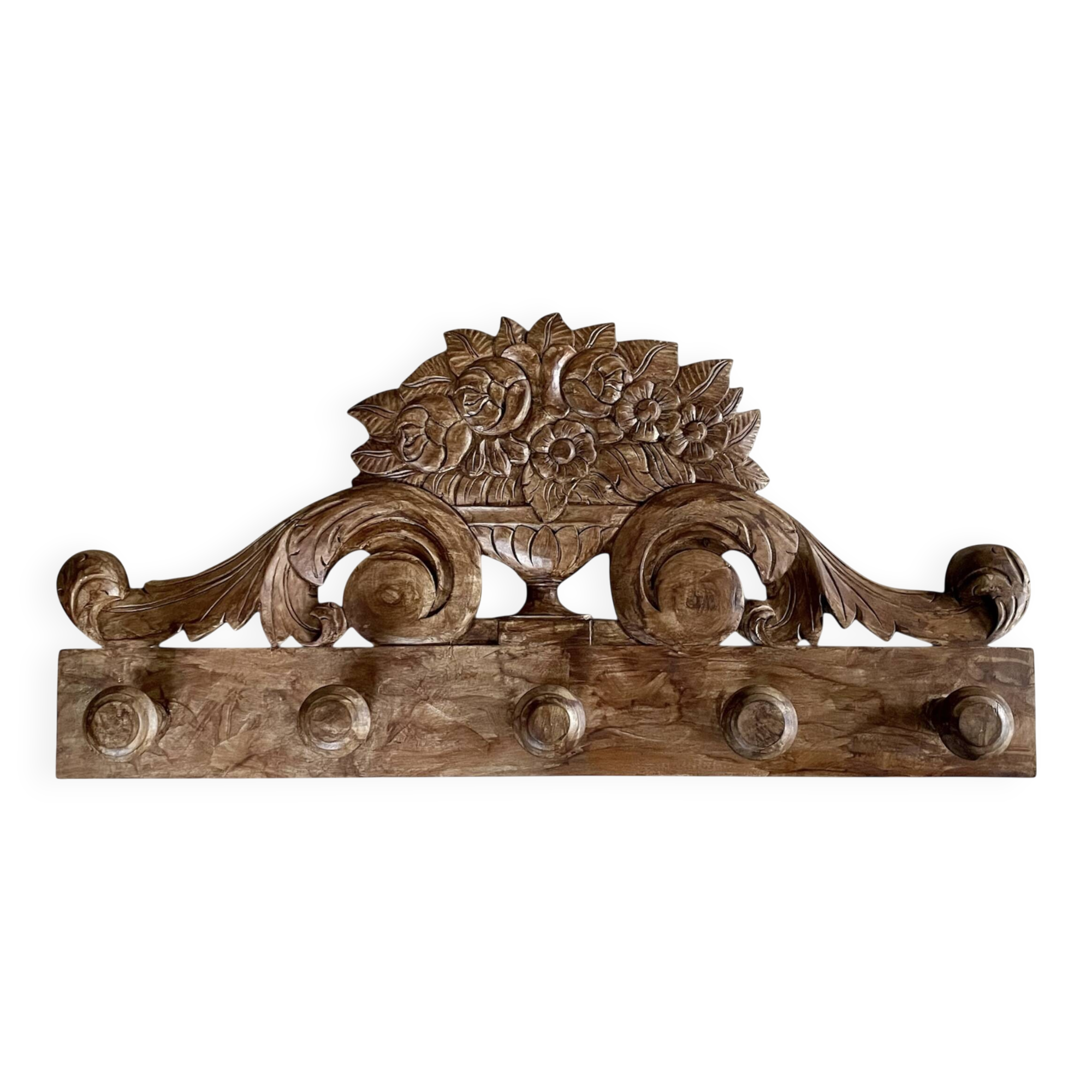 Wall-mounted coat rack on a carved wooden pediment