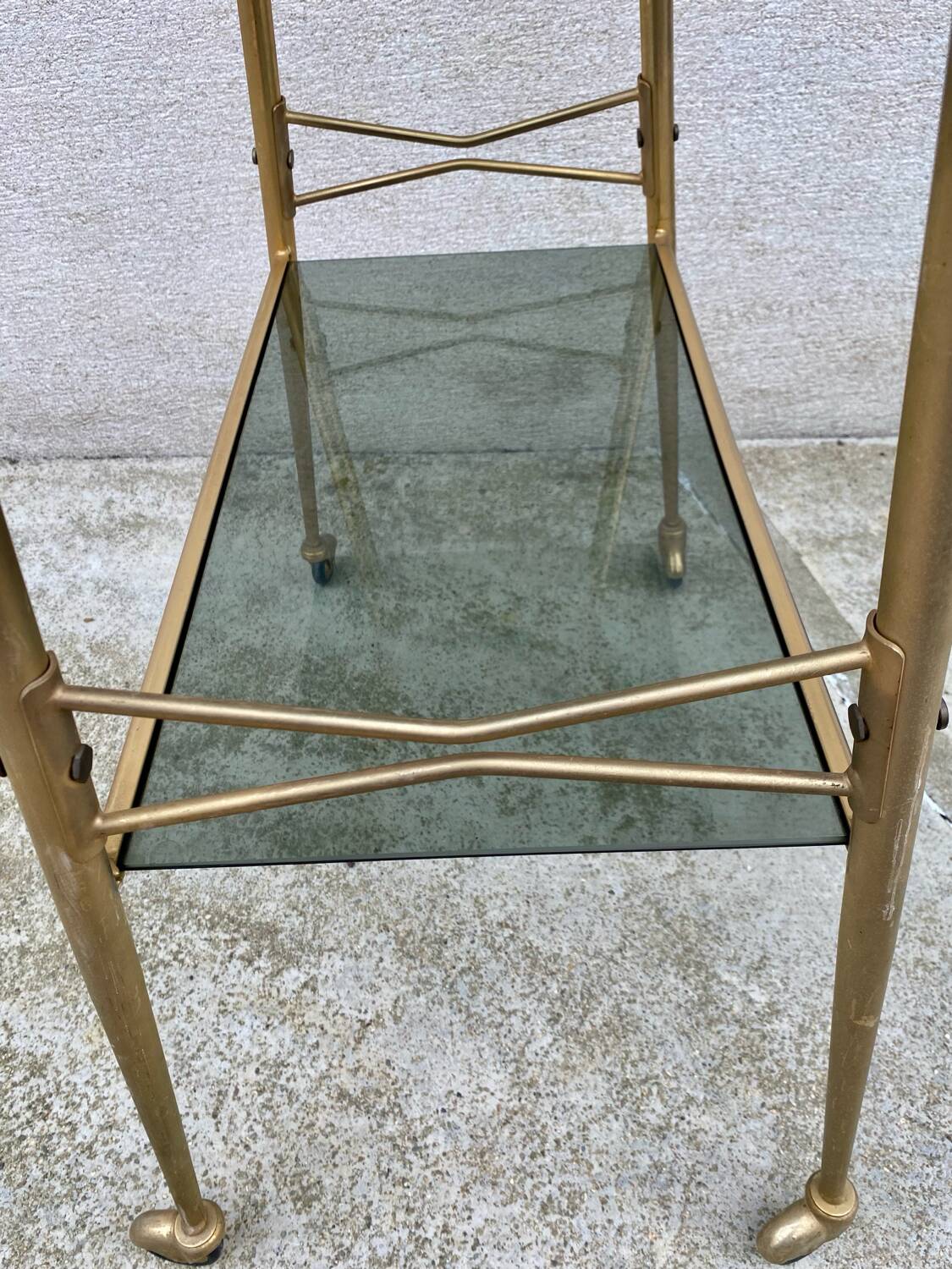 Vintage 1970s glass and gold rolling console table.
