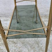 Vintage 1970s glass and gold rolling console table.