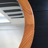 Round mirror in varnished pine