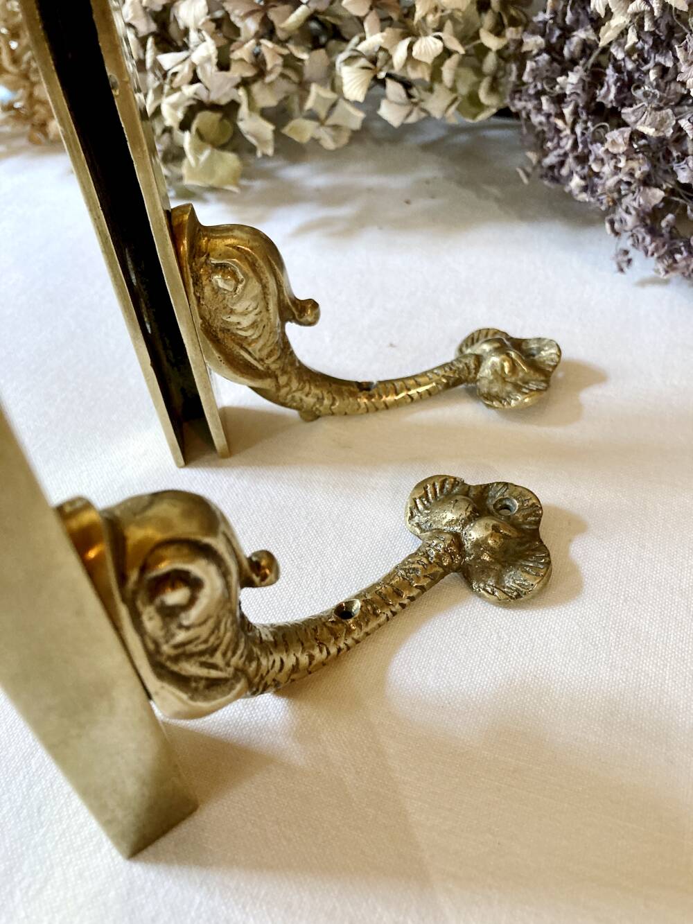Brass wall supports for bathroom shelf, circa 1950.