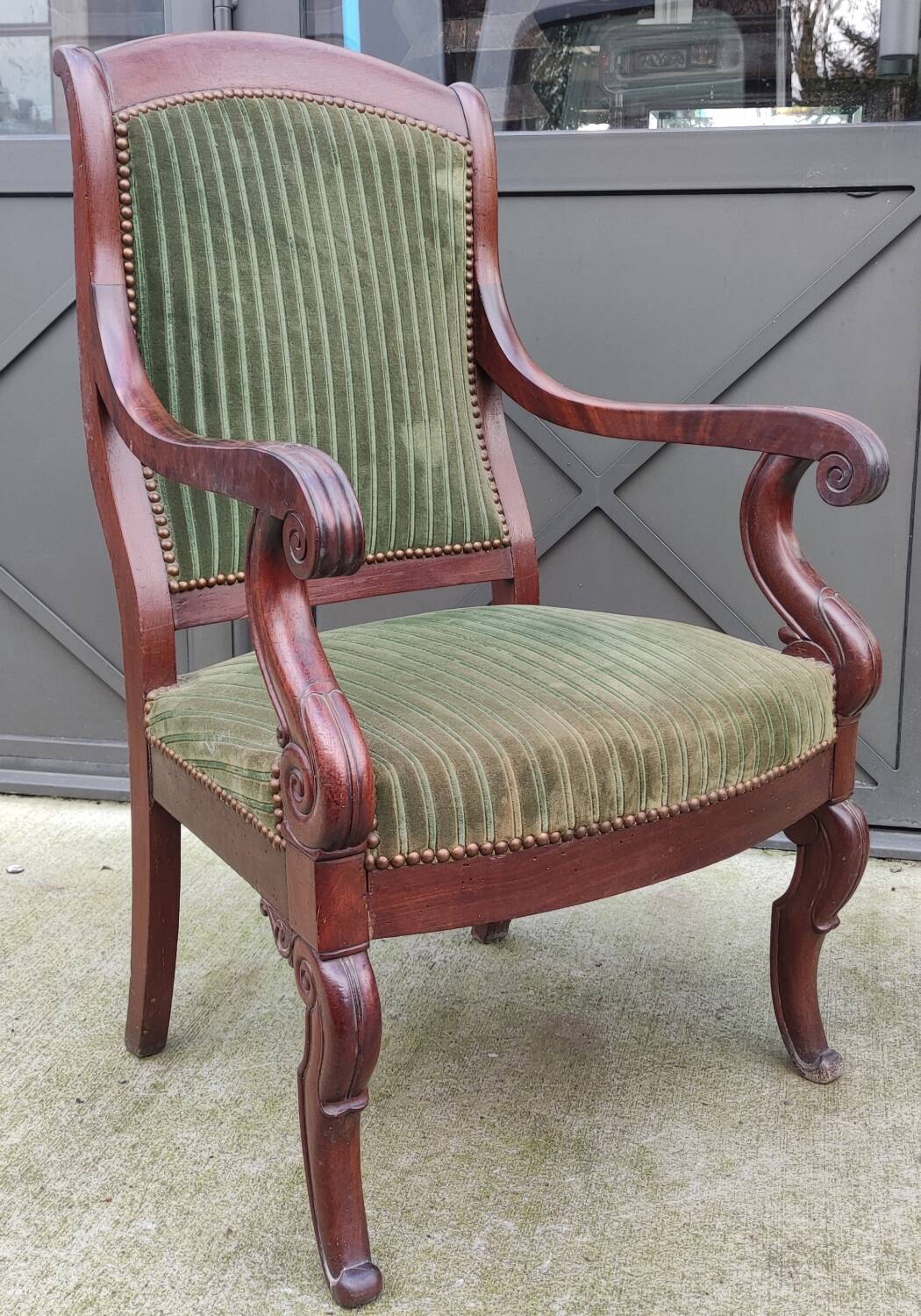 Old green velvet armchair