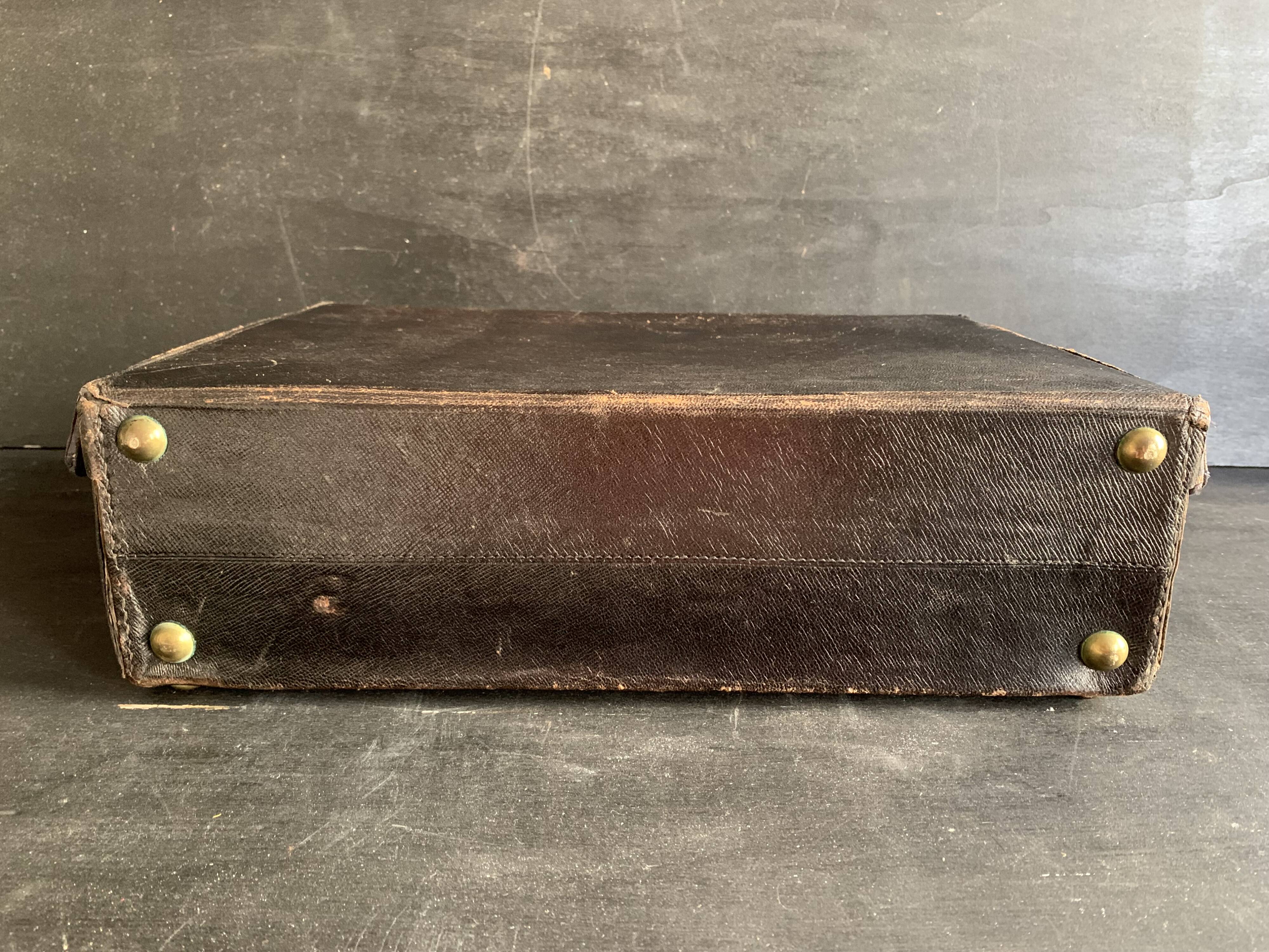 Small black grained leather travel suitcase from the 1920s