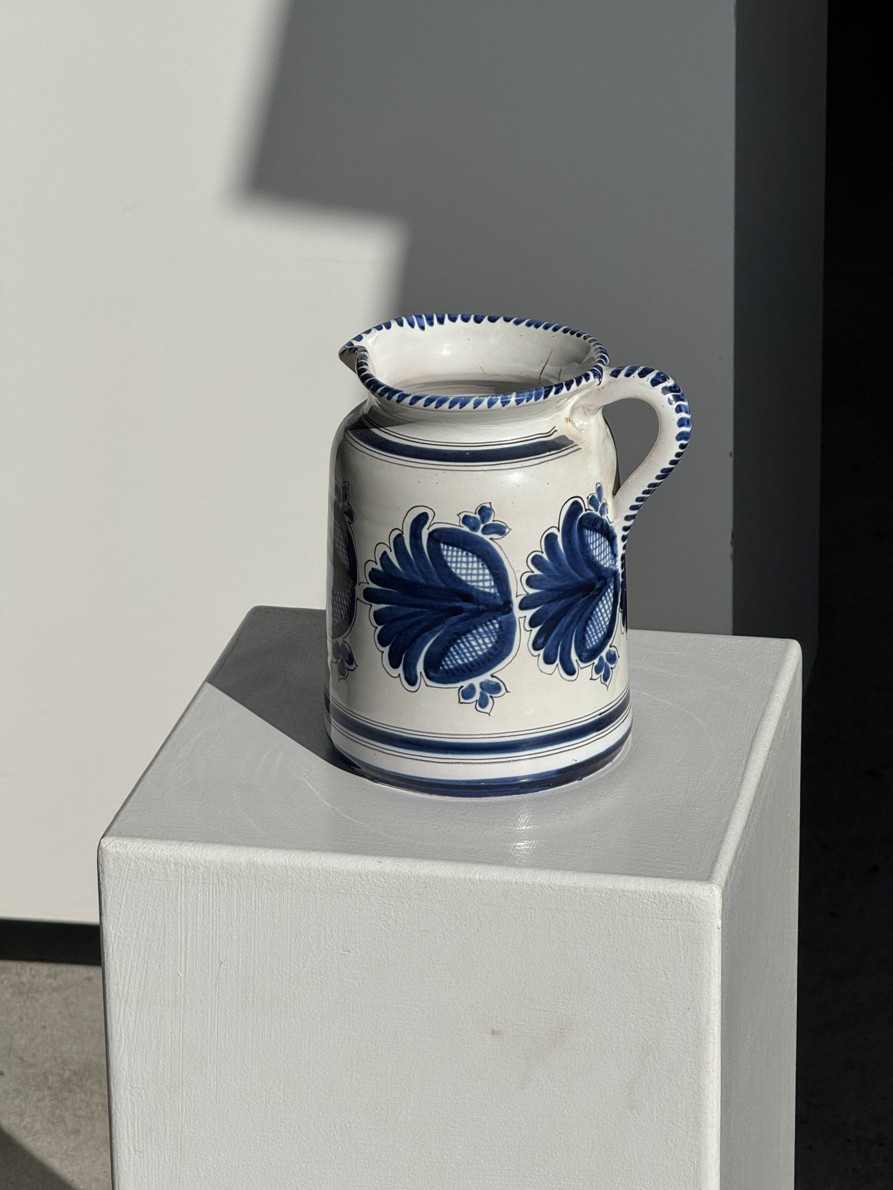 Artisan blue floral decorative carafe, height 17 cm, diameter 24.5 cm.