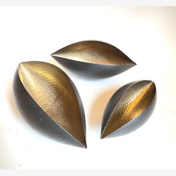 3 cups in folded hammered brass and black lacquered on the outside. In the style of Serge Mouille.