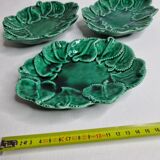 Set of three enamelled, emerald green, leaf-decorated faent cups